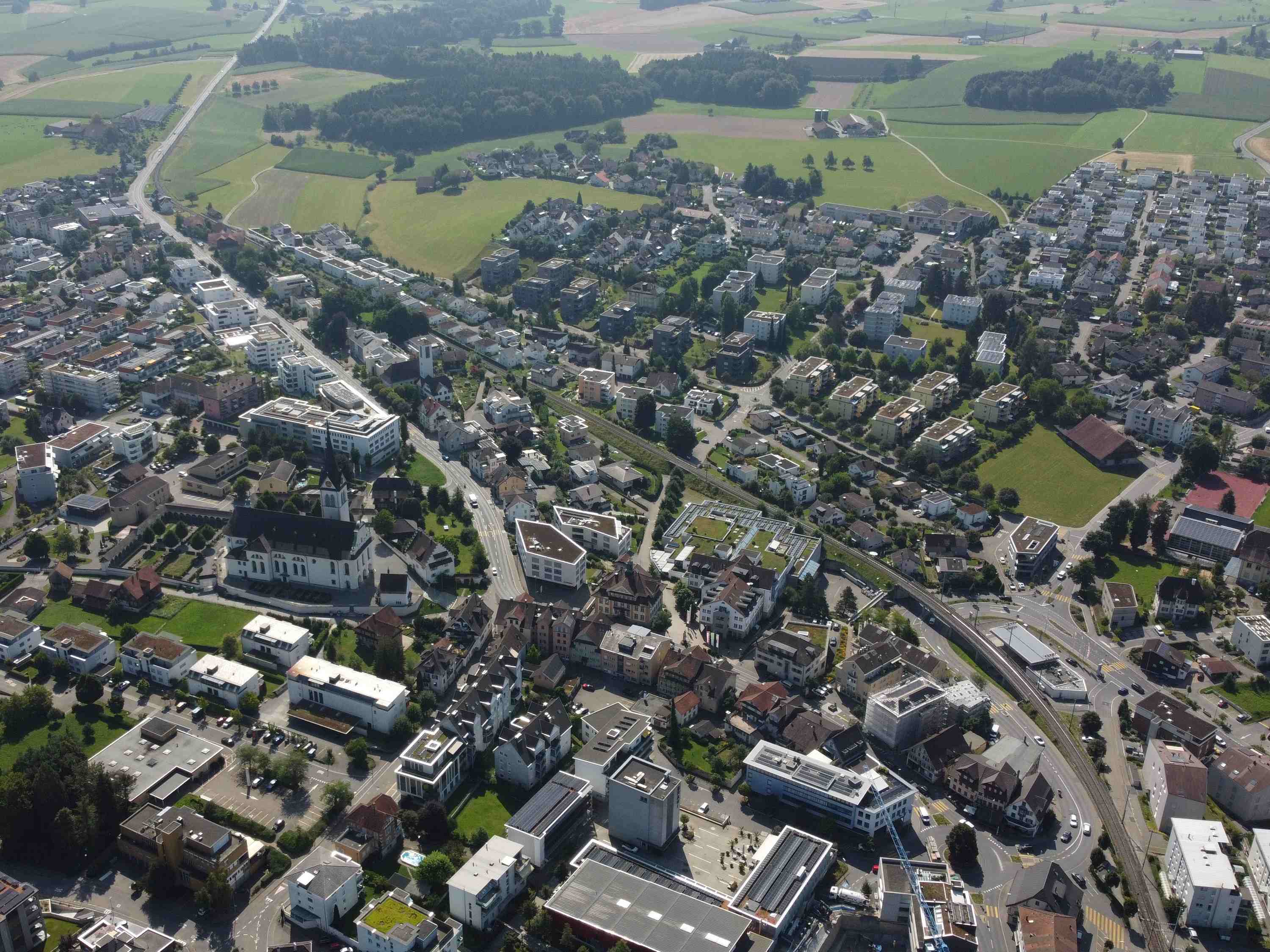 Blick über Hochdorf Zentrum im Seetal; mit Kirche und Wohnhäuser im Vordergrund
